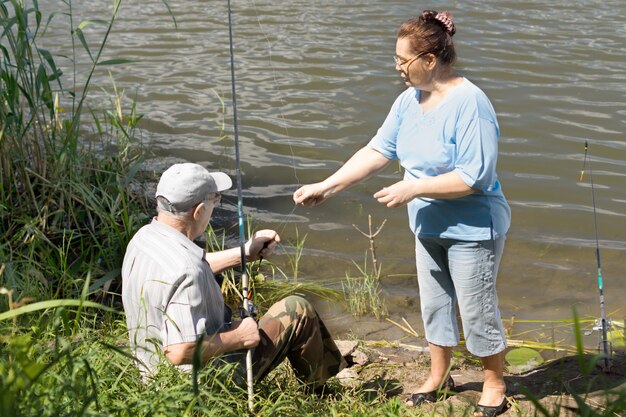 Elderly couple fishing on a freshwater lake