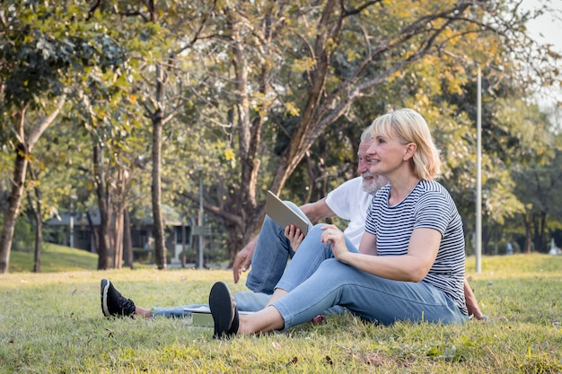 Elderly couple on the grass in the park