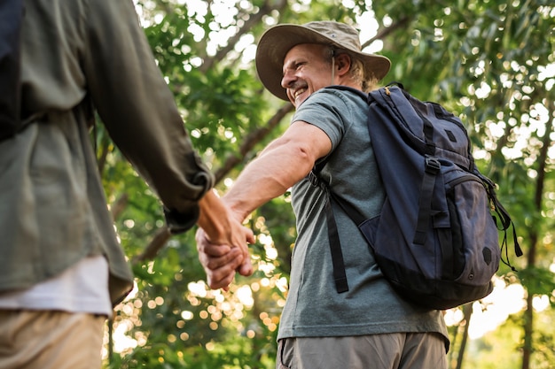 Elderly couple holding hands in the forest