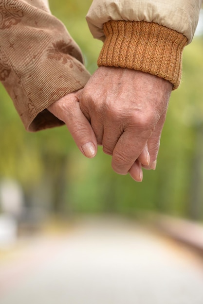 Elderly couple holding hands