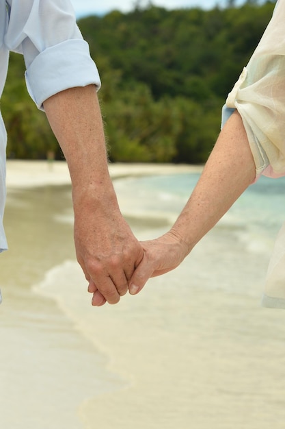 Elderly couple holding hands