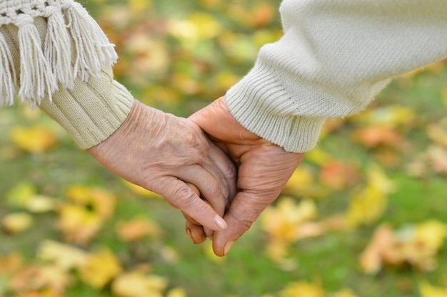 Elderly couple holding hands