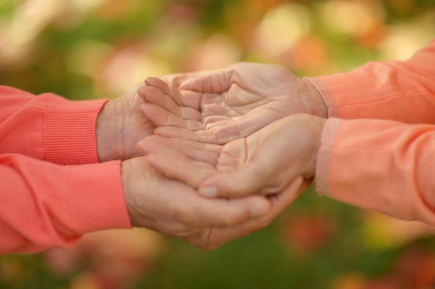 Elderly couple holding hands