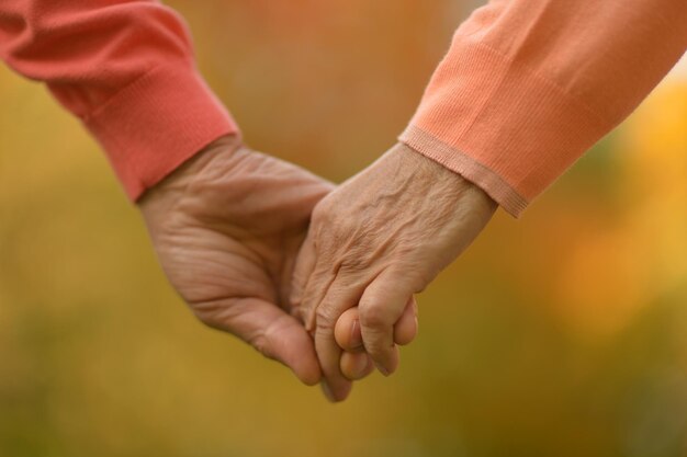 Elderly couple holding hands