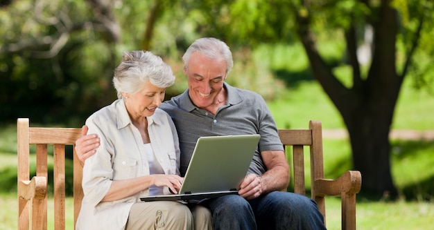 Elderly couple looking at their laptop