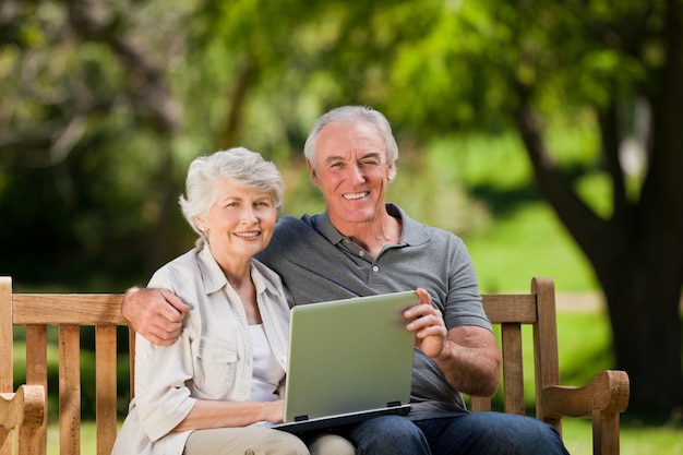 Elderly couple looking at their laptop