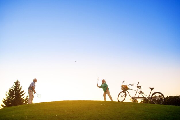 Elderly couple playing badminton