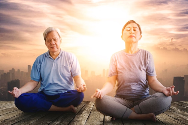 Elderly couple practicing yoga at outdoors