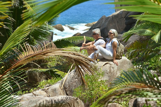 Elderly couple rest at tropical beach