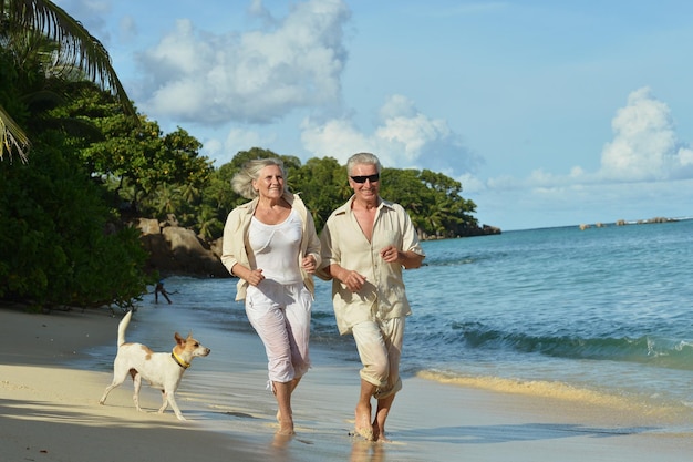 Elderly couple running on beach