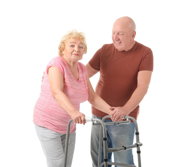 Elderly couple with walking frame on white background