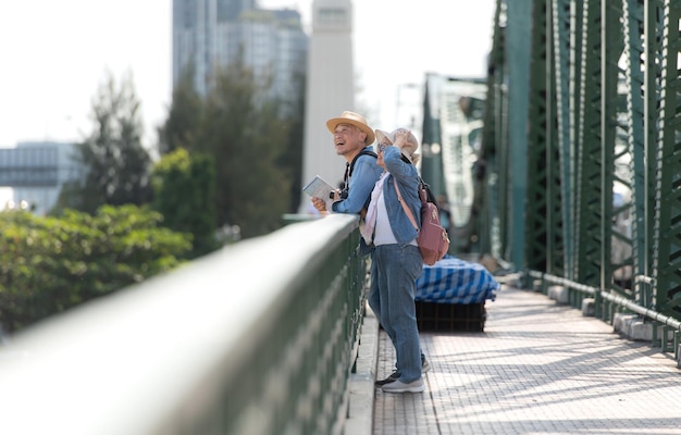 elderly couples travel on the old iron bridge phra phutthayotfa bridge in bangkok thailand