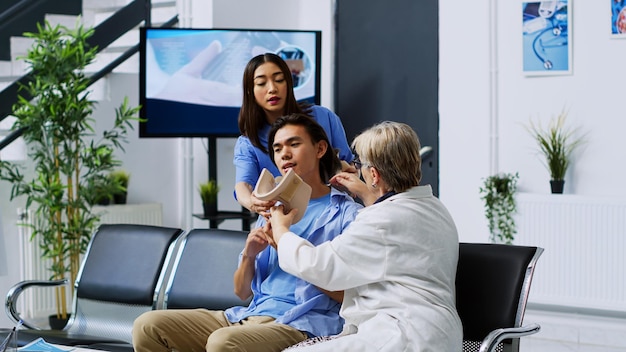 Elderly doctor helping patient