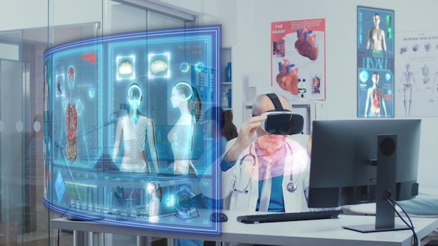 Photo elderly doctor using vr headset to check holographic augmented reality visualization of body scans sitting at clinic desk computer. expert working in medical office looking at anatomy graphics
