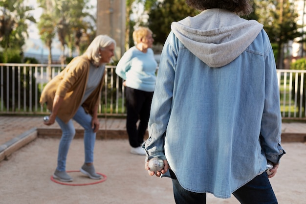 Elderly friends playing petanque