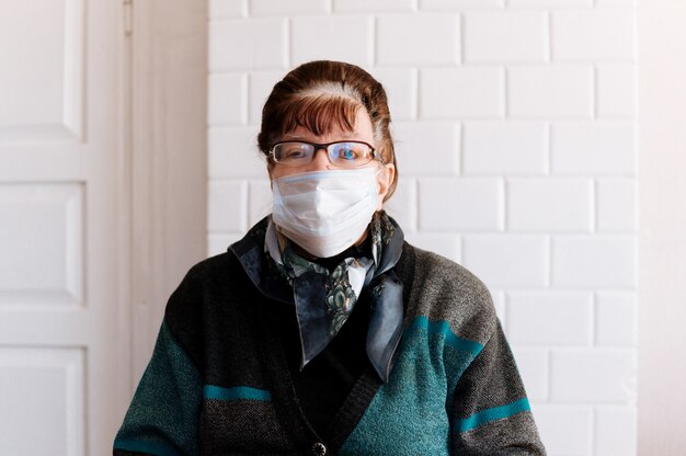 Elderly grandmother with a surgical medical mask