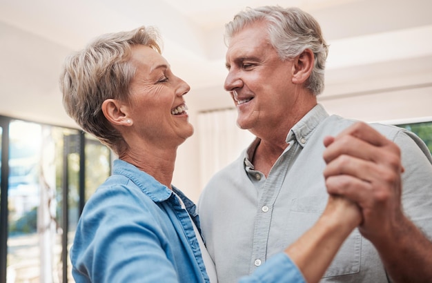 Elderly happy and dancing couple in living room enjoying retirement Portrait of senior man and woman who dance together in their home smiling loving and romantic Family love and fun old people