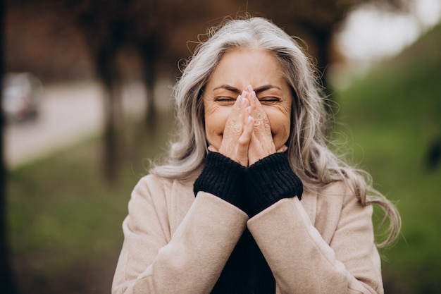 Photo elderly happy woman walking in park