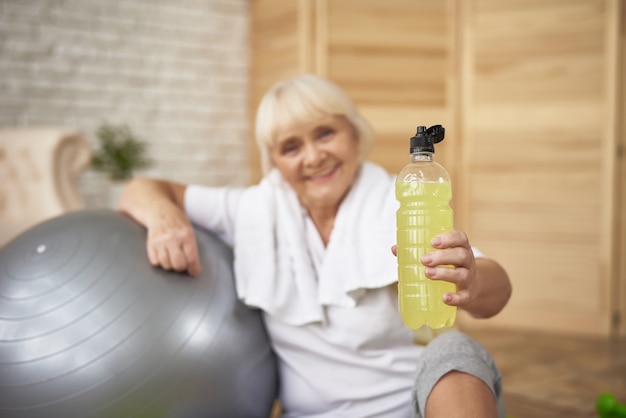 Elderly Lady Has Lemon Detox Water Doing Sports.