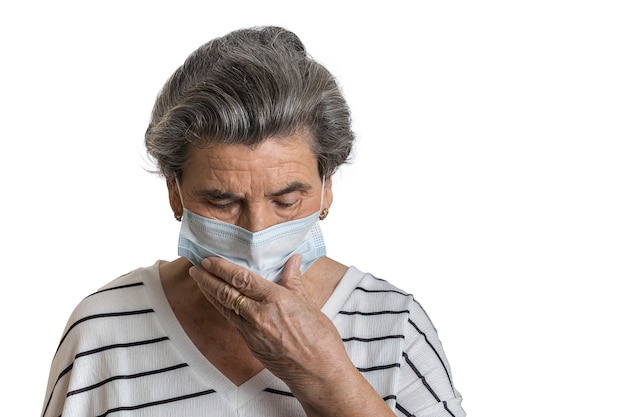 Elderly lady in medical mask coughing