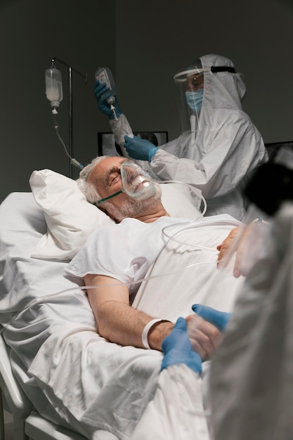 Elderly man breathing with a special equipment