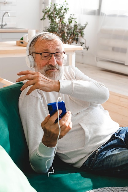 Elderly man cool bearded old man using mobile phone for video\
call happiness elderly lifestyle peopl