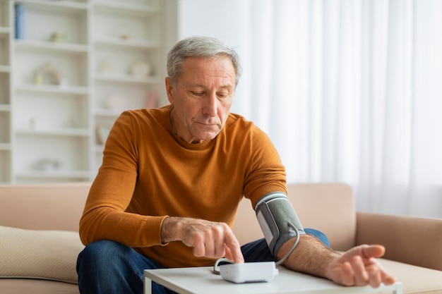 Elderly man doing morning checkup after waking up