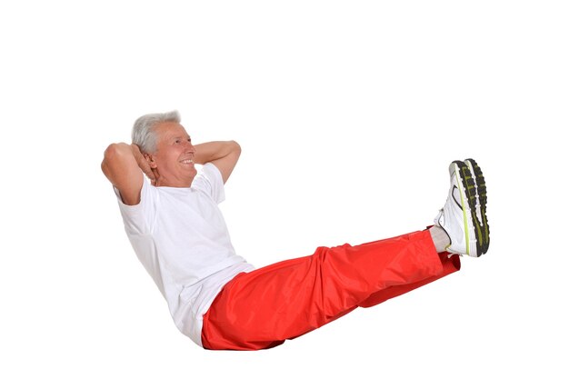 Elderly man exercising on a white background