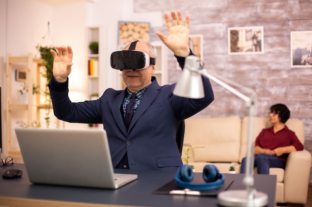 Elderly man experiencing new virtual reality technology for the first time in his home