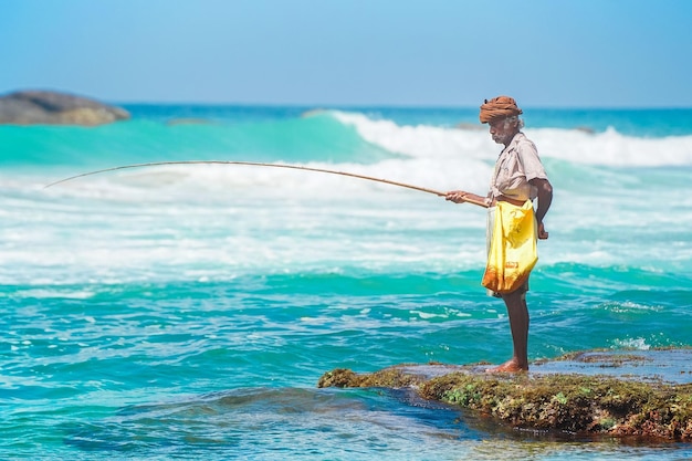 Elderly Man Fishing in the Sea Photo