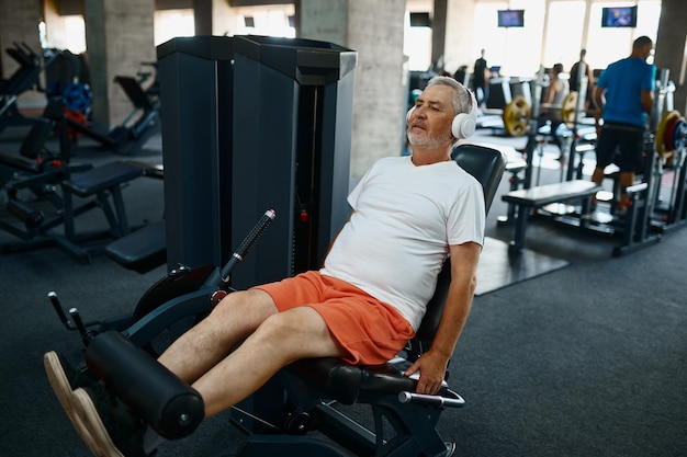 Elderly man in headphones doing abs exercise