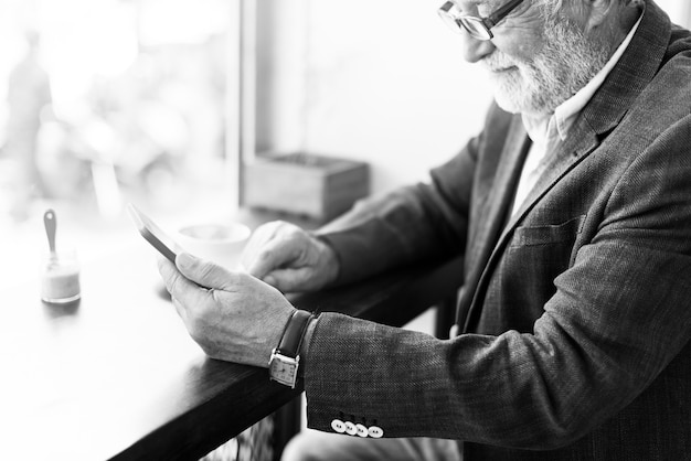 Elderly man is using digital tablet