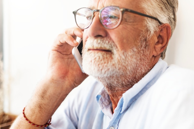 Elderly man is using mobile phone