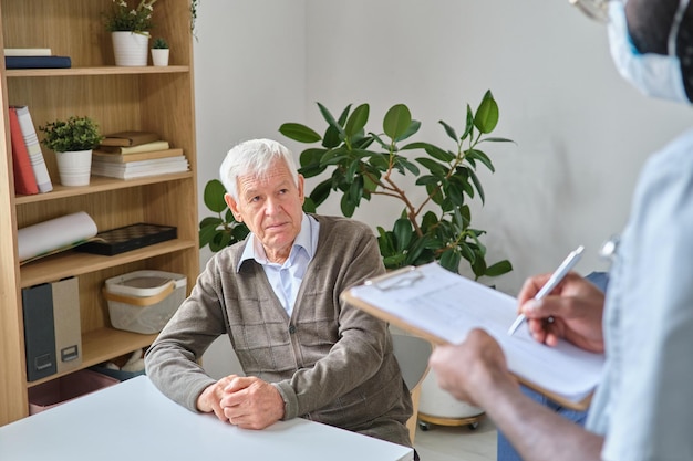 Elderly man listening to the prescription of the doctor