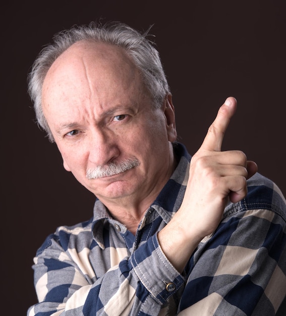 Elderly man pointing up