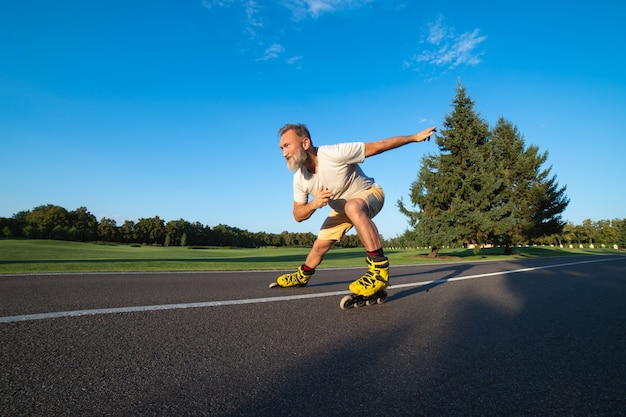 The elderly man rollerblading on the alley