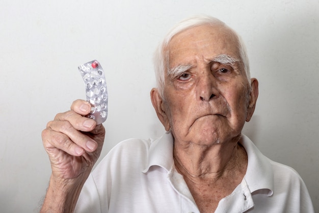 Elderly man sad about running out of medicine