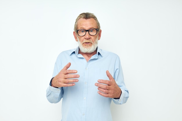 Elderly man in shirt and glasses posing emotions isolated background