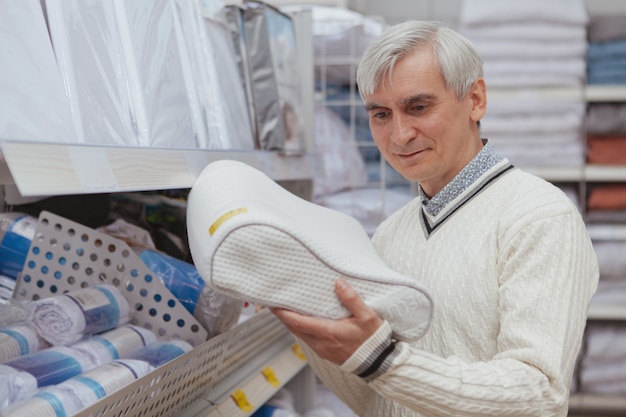 Elderly man shopping at home goods store