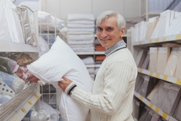 Elderly man shopping at home goods store