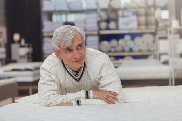 Elderly man shopping at home goods store