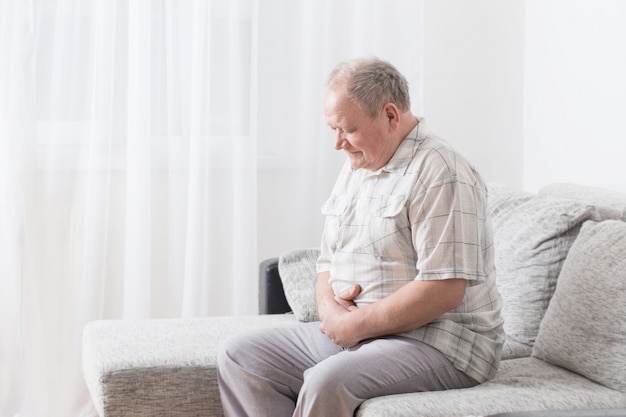 Elderly man sitting on a couch