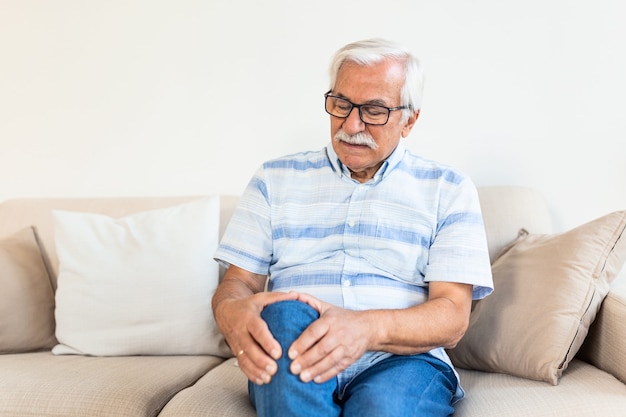 Elderly man sitting on a sofa at home