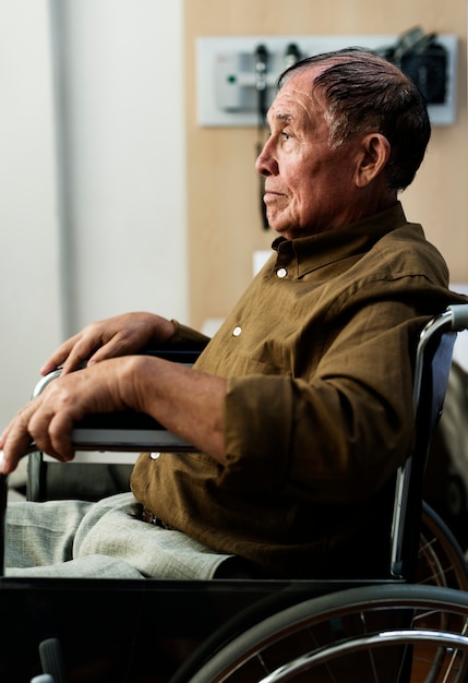 an elderly man sitting on a wheelchair