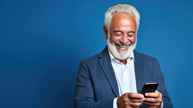An elderly man smiling and laughing with his phone against a colored background