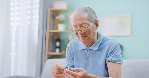elderly man use glucometer