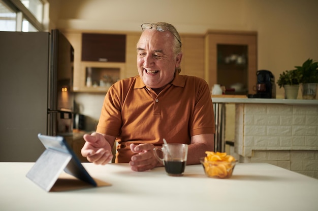 Photo elderly man video calling friend