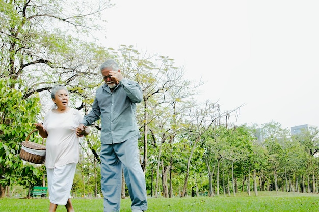 Elderly man walking with his wife in hot weather and walking too much is suffering from heatstroke