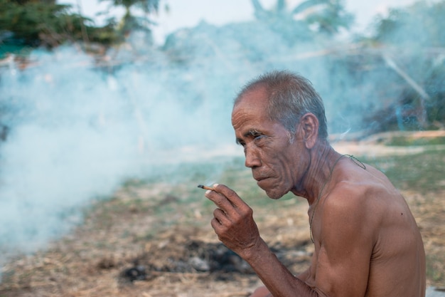 Elderly man was sitting smoke
Elderly man was sitting smoke while break from work