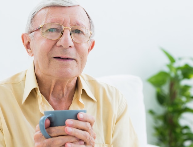 Elderly man with a cup